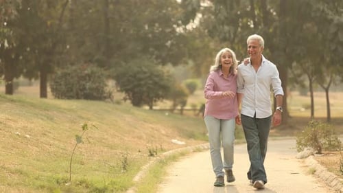 Old Sweet Couple Enjoys A Peaceful Walk in the Park