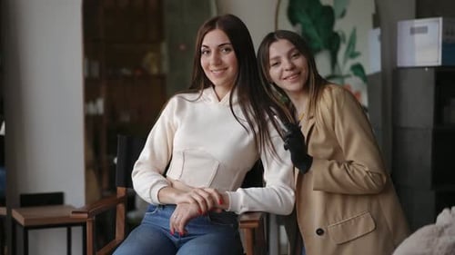 Two Smiling Women Posing in Beauty Studio