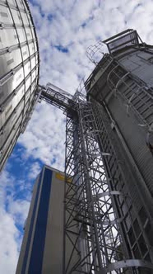 Grain Silos Towering Against Blue Sky