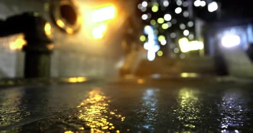 Urban Nighttime Alley with Reflections and Glowing Lights From Buildings
