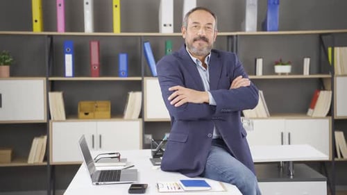 Man Working Atop Desk in Office Environment