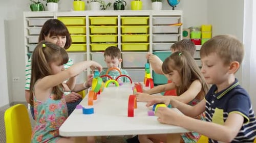 Children Building Colorful Arches with Blocks in Classroom