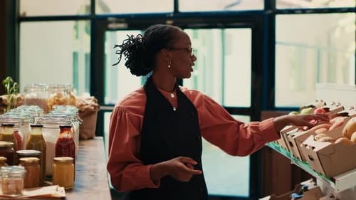 Enthusiastic Woman Presenting Fresh Goods in Grocery Store