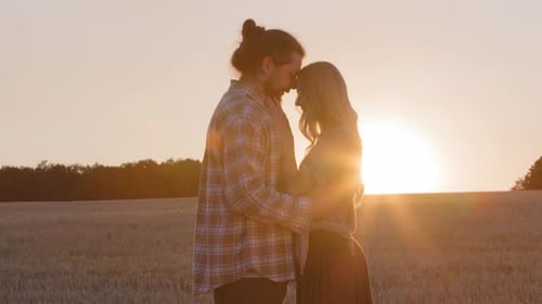 Romantic Couple Embracing in Golden Sunset Field