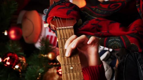 Person Plays Guitar at Christmas Time