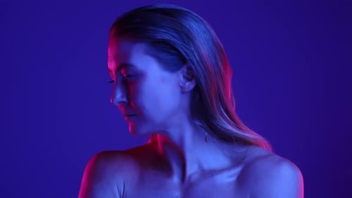 Woman Posing in Neon Lit Studio Close-Up
