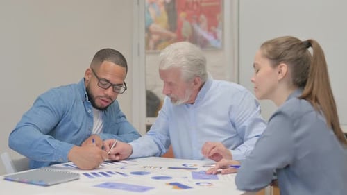 Mixed Race Business People Discussing Work in Office
