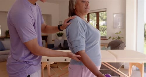 Woman Exercises with Assistance of Physical Therapist