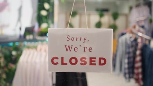Closed Sign on Clothing Store Door