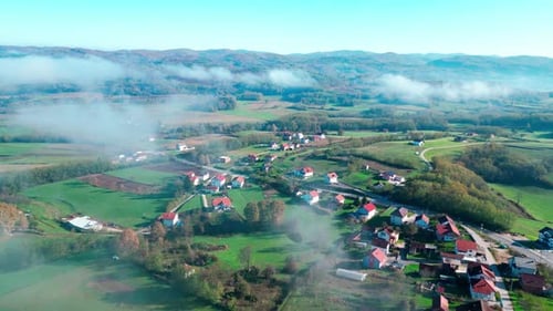Serene Village in a Blanket of Morning Fog