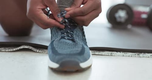 Hands shoelace, prepare sports and man workout, cardio and wellness gym training on floor