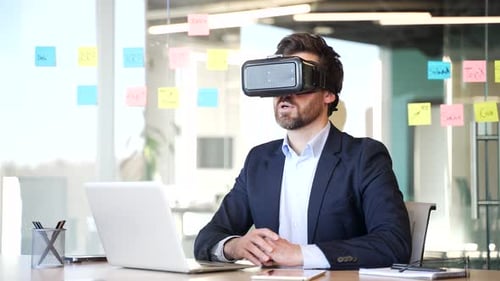 Man Gesturing with VR Headset in Office
