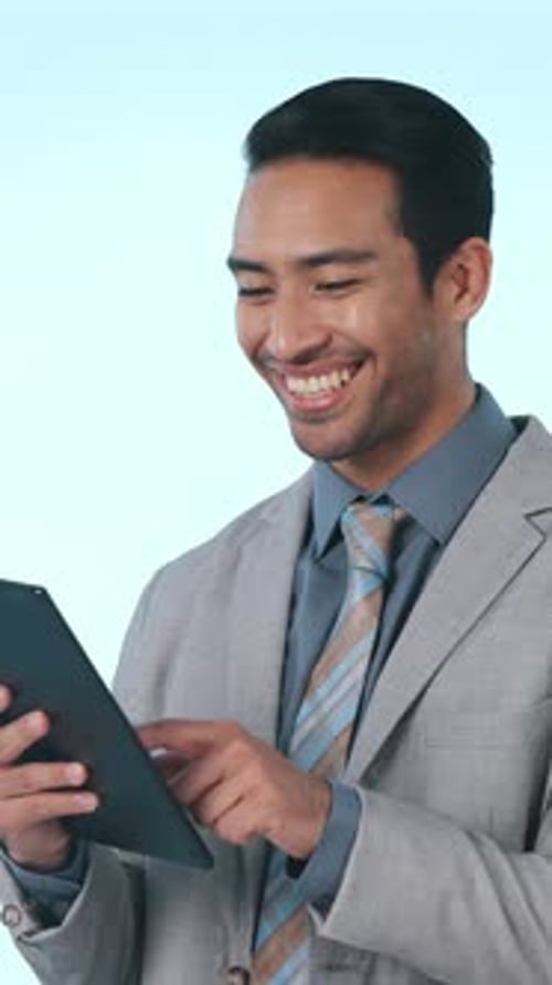 Happy, tablet and business man in studio with good news for investment, stock market and trading
