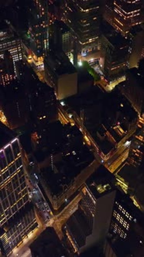 Flying high above the lively traffic streets at night time. Splendid Manhattan architecture