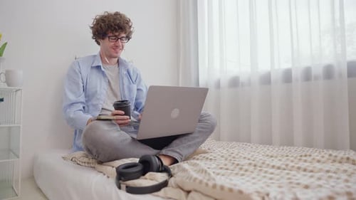 Young Man Working Remotely in Bright Home Office
