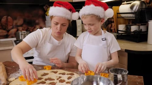 Woman and Child Baking Christmas Cookies Together