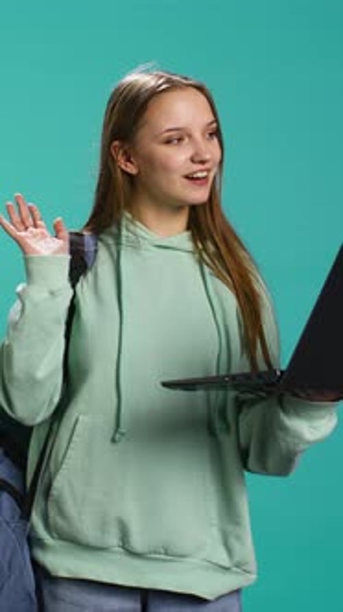 Young Adult Chatting on Laptop Video Call