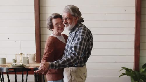 Elderly Couple Dancing Together at Home