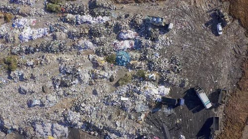Aerial View of Sprawling Landfill Site with Trucks