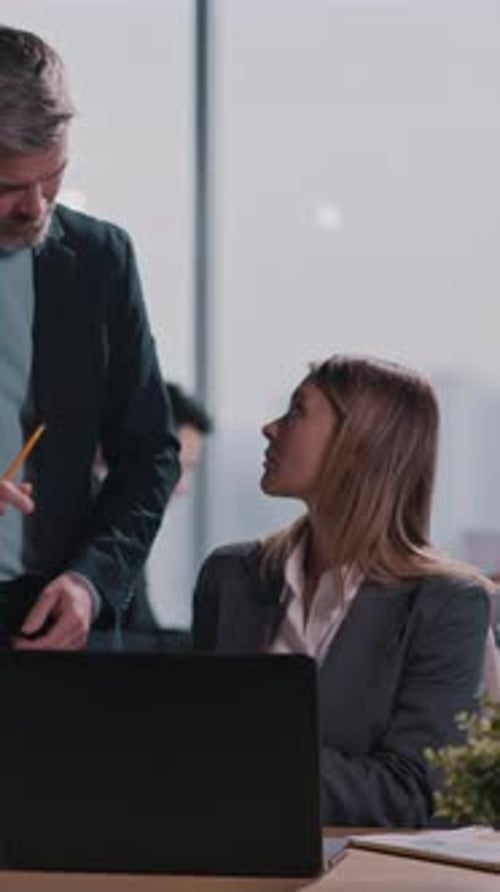 Businesswoman Discusses Work in Modern Office Environment