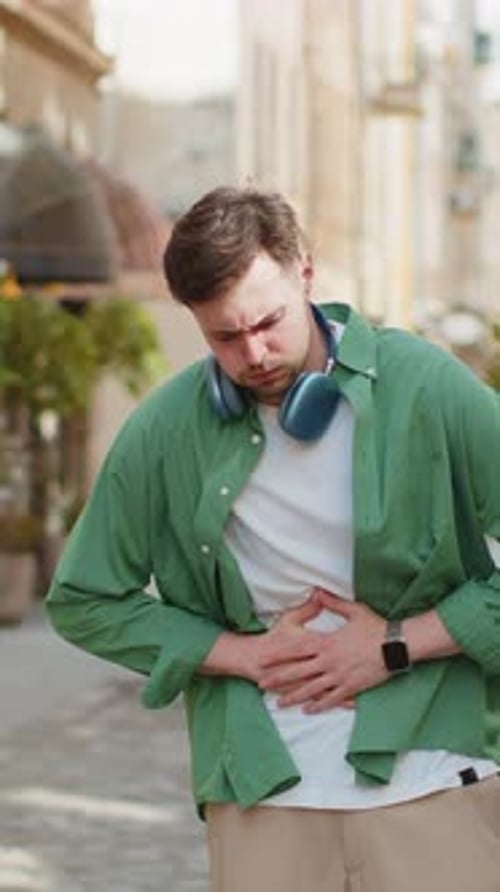 Man Tourist Feeling Sudden Strong Abdominal Stomach Ache Diarrhea Gastritis Problem on City Street