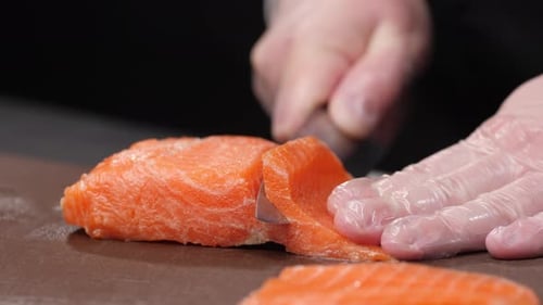 Chef Slicing Fresh Salmon for Delicious Cuisine