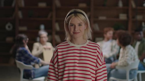 Optimistic Young Woman at Group Meeting