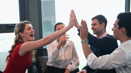 Smiling Colleagues Giving High Five in Bright Office