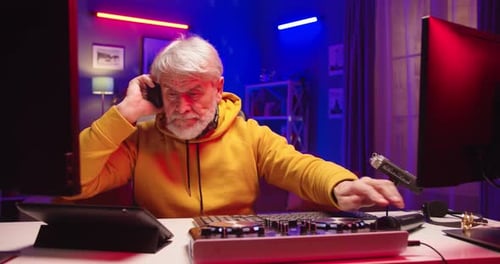 Close Up of Handsome Caucasian Funny Modern Happy Old Man Mixing on Vinyl Plate Streaming Live