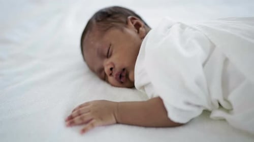 Closeup portrait of african happy baby sleeping sweet dream on bed