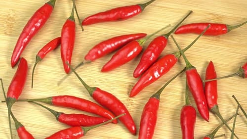 Vibrant Red Chili Peppers Arranged on Wooden Surface