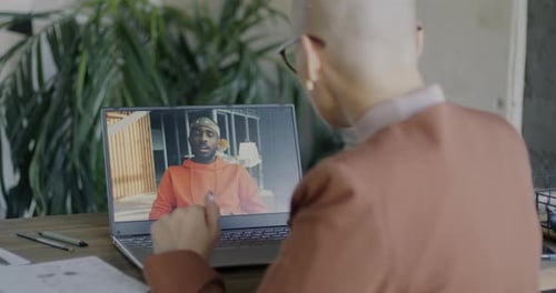 Adult Having Video Call on Laptop at Desk