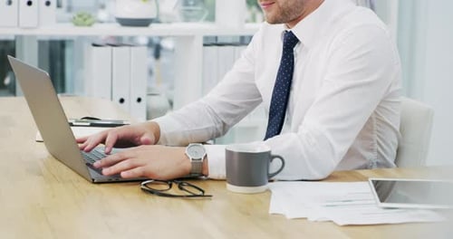 4k video footage of an unrecognisable businessman working on a laptop in an office