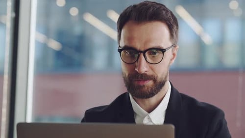 Adult Working on Laptop in Office Close Up