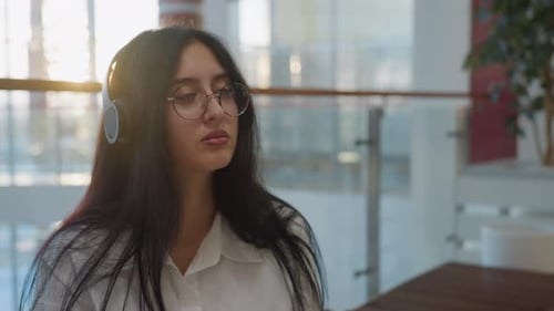 Woman Listening to Music with Headphones Indoors