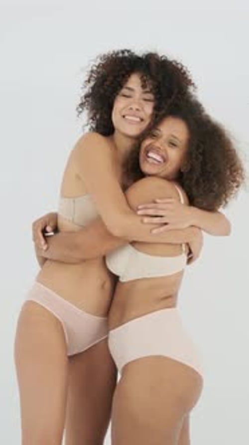 Women with Curly Hair Embracing in Underwear