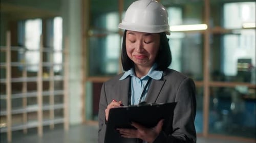 Asian Woman Builder Architect Inspector Approve Construction Plan Building Project Writing Notes