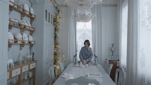 Young Woman Arranging Teacups on Formal Dining Table