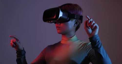 Woman Using Virtual Reality Headset in Dark Room