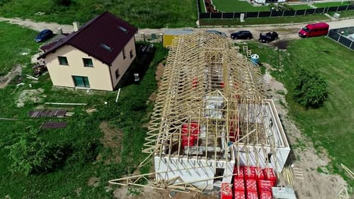 Aerial view of the construction of a roof with wooden trusses.