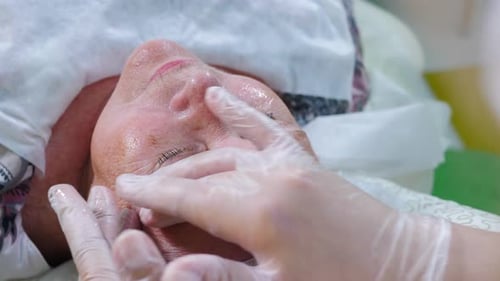 Aged Woman Receiving Face Massage in Beauty Spa Clinic Beauty Antiaging Face Lifting and Dermatology