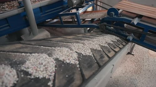 Recycled Plastic Pellets on Industrial Conveyor Belt
