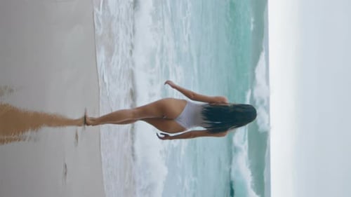 Woman Going Swim Ocean Cloudy Day Girl Walking Beach to Foamy Waves Vertically