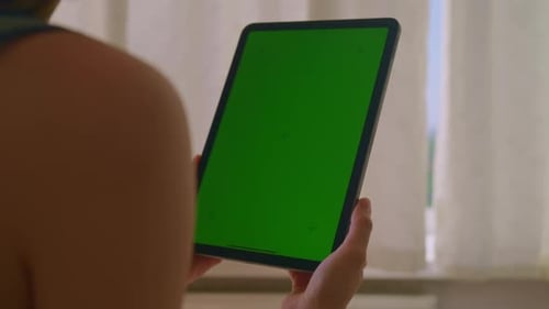 Woman Holding Device with Green Screen