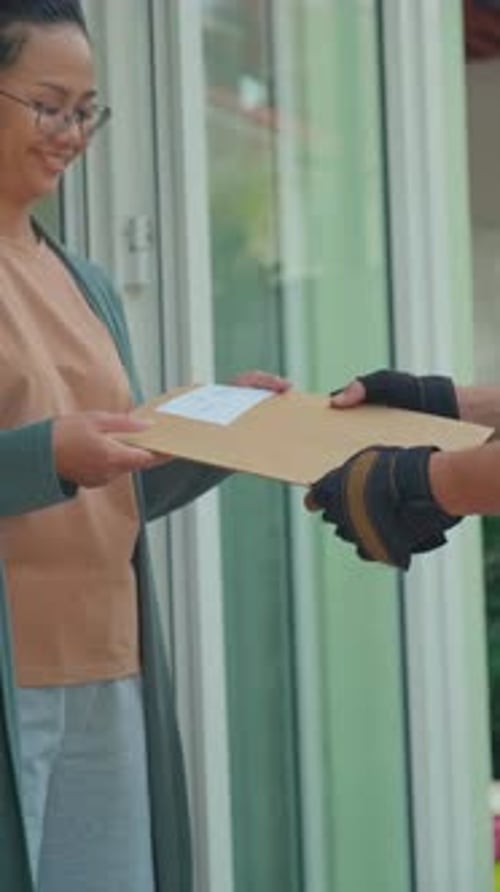 Woman Receiving Envelope Delivery Outside Her Home