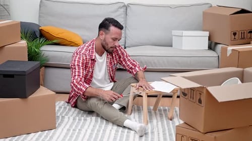 Man Assembling Furniture in a New Home