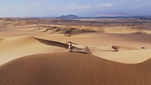 Aerial View of Sand Dunes in Peru Solitary Walker Amidst Vast Landscape