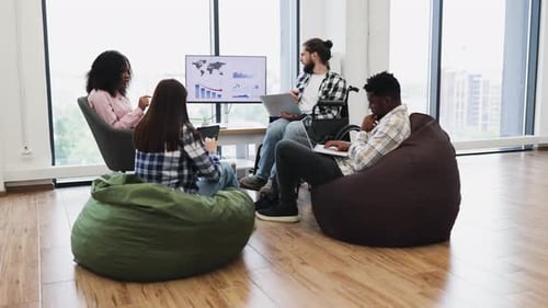 Diverse Group of Young Adults Collaborating in Casual Modern Office Setting