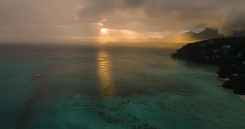 Sunset Light Over Ocean with Distant Hills and Cloudy Sky Seychelles Mahe