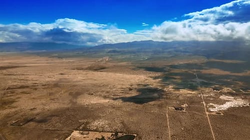 White cloudscape slowly floating in the air covering the desert from sun.